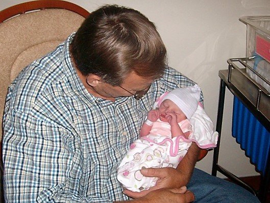 grandpa holding newborn daughter
